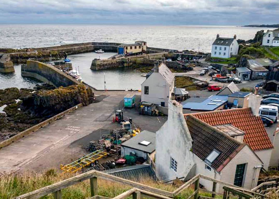 Fishing boats and pastel cottages line St Abbs harbour, one of the prettiest spots on the east coast of Scotland.