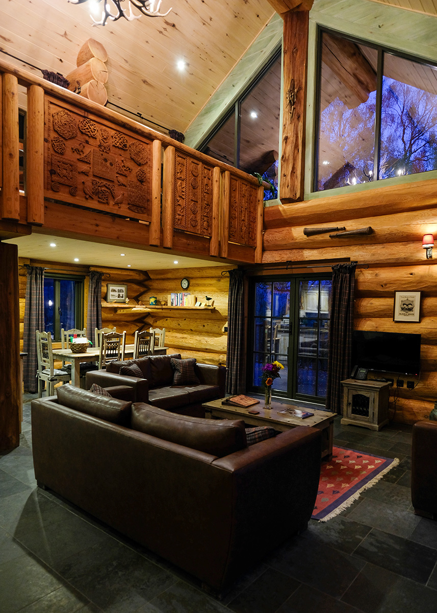 Inside Eagle Brae: soaring cedar beams and Himalayan carvings.