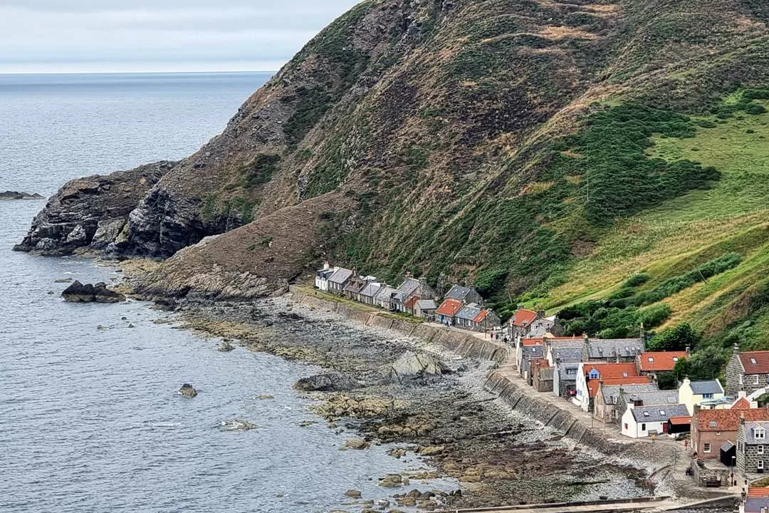 The postcard-perfect fishing cottages of Crovie, tucked beneath the cliffs on the Moray Firth coastline.