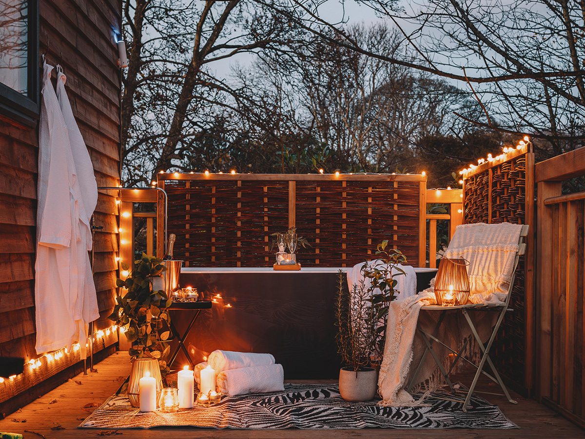 Outdoor bath at the Treehouses in Fife with fairy lights and lanterns