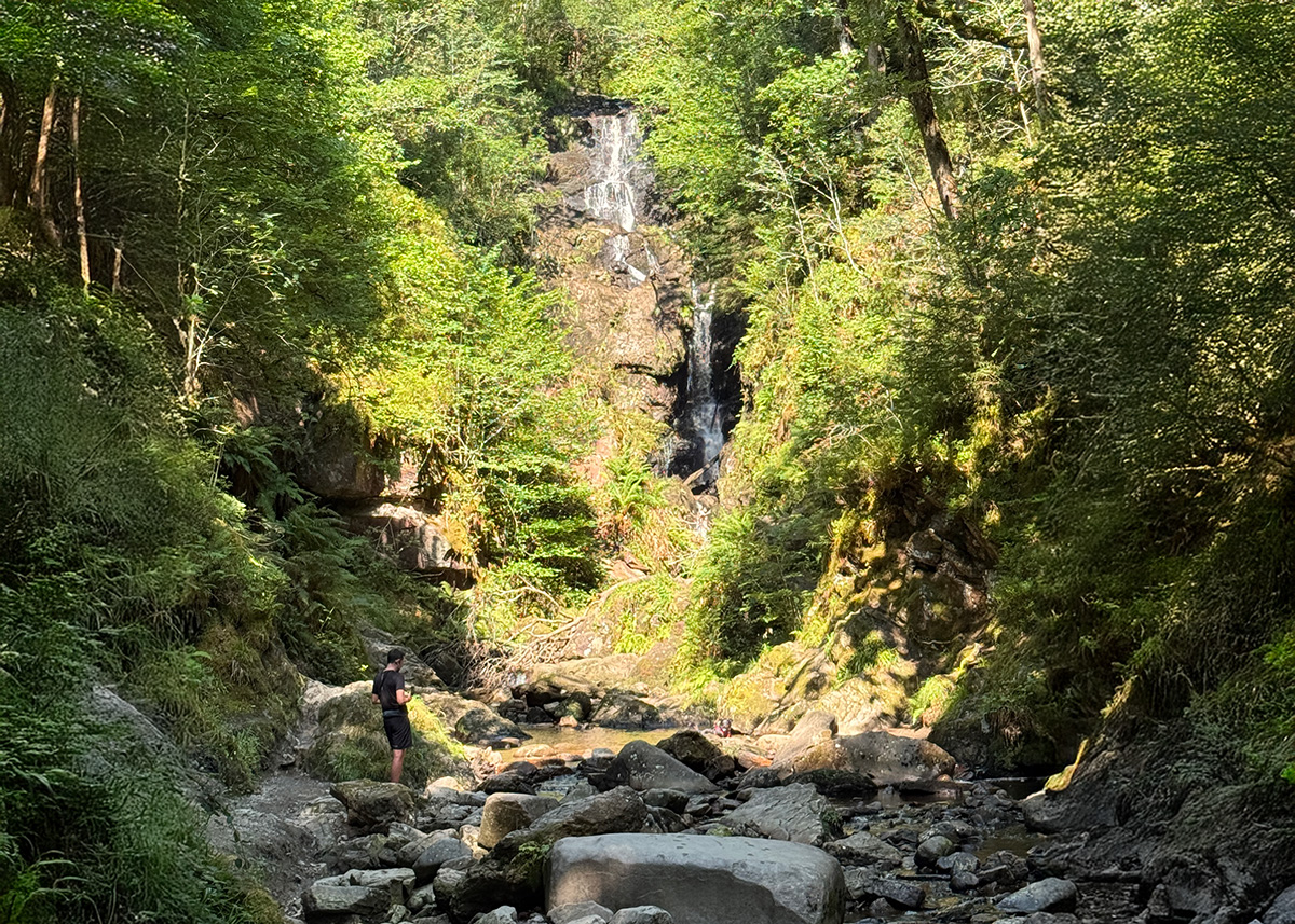 A hidden woodland waterfall reached via the short, family-friendly Waterfall Trail near Aberfoyle.