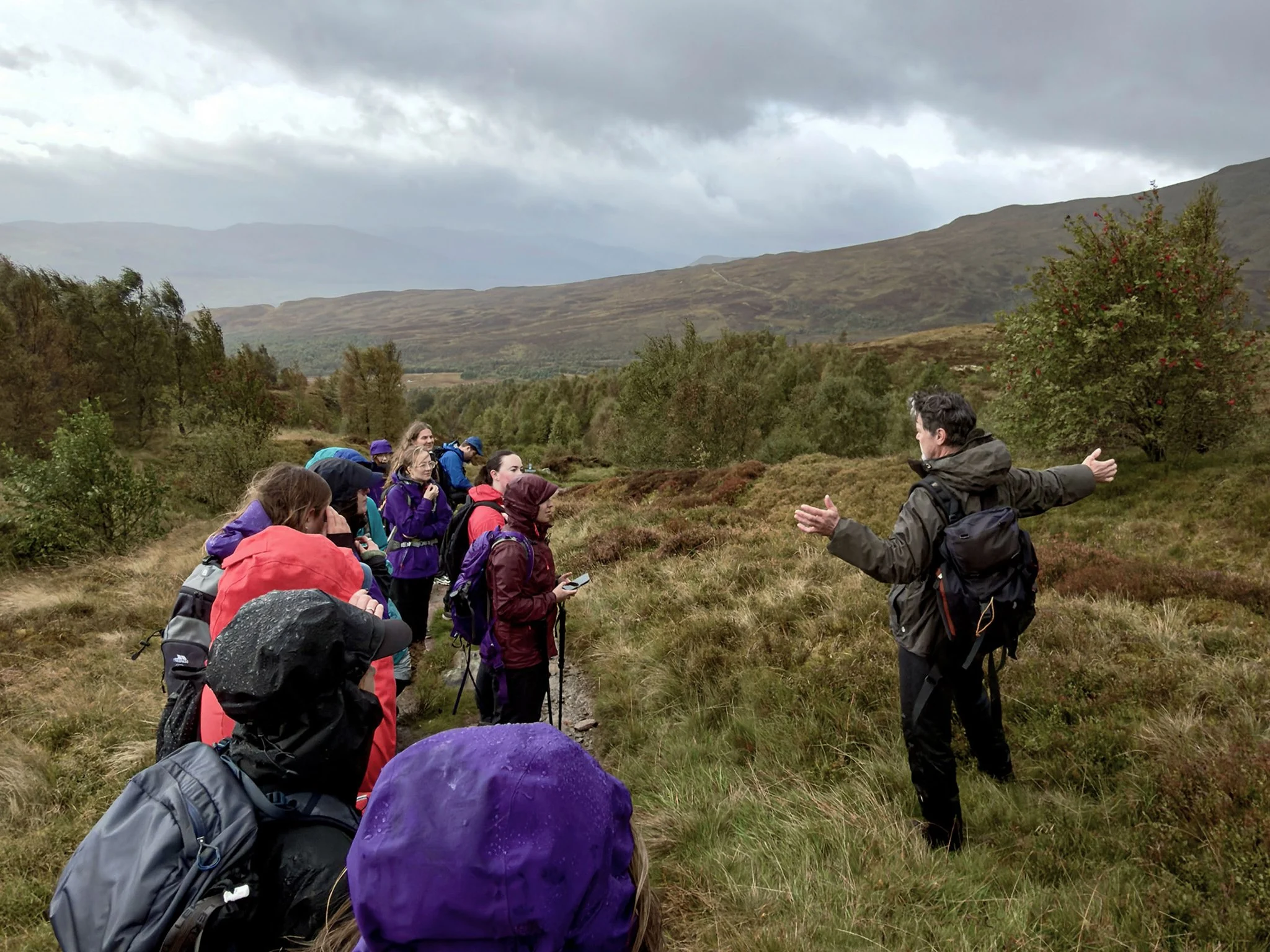 Ranger explaining the restoration work ongoing on Ben Lawers to a group of hikers